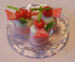 3 cherry cakes on a glass plate