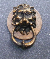 a dolls house miniature antiqued door knocker