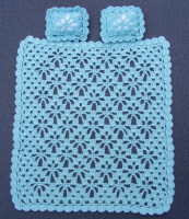 blue crochet blanket and 2 pillows